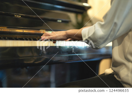 A woman's hand playing the piano 124496635