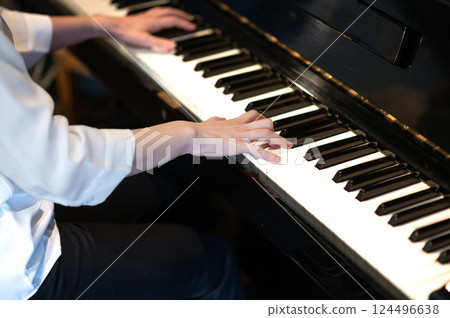 A woman's hand playing the piano 124496638