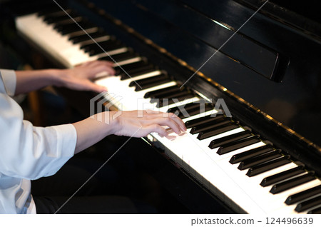 A woman's hand playing the piano 124496639