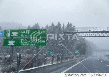 Snowfall on the Joban Expressway, Hitachi Chuo Interchange exit sign 124496731