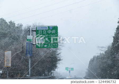 Snowfall on the Joban Expressway, Hitachi Chuo Interchange exit sign 124496732