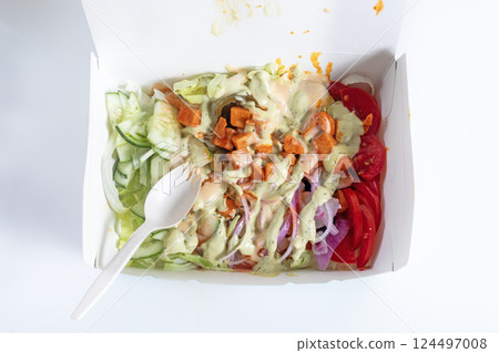 Fresh salad box with toppings and creamy dressing with spoon Fresh salad box with toppings and creamy dressing with spoon 124497008