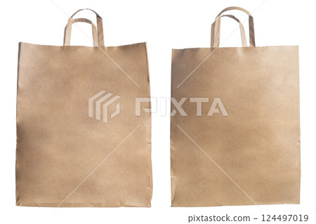 Eco-friendly craft paper bags with handles for shopping or packaging needs. 124497019