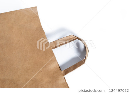 Eco-friendly brown paper bag with handles on white background Eco-friendly brown paper bag with handles on white background 124497022