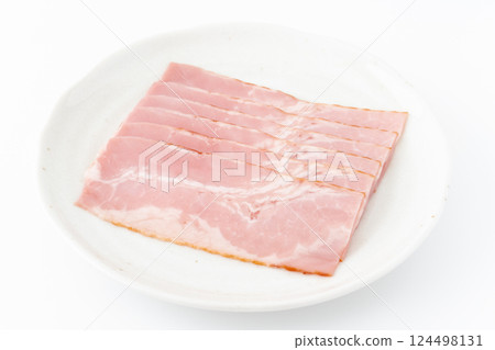 Slices of bacon on a plate 124498131