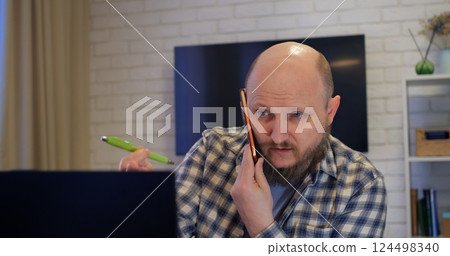 Bald man talking on video call, revealing fatigue from nonstop work, letting fatigue erode mental clarity, cautioning how fatigue undermines well-being without proper breaks. Drinks coffee 124498340