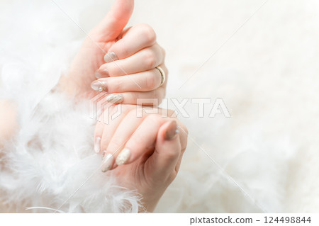 Hands with nails done at a nail salon (magnetic gel, mirror line) 124498844