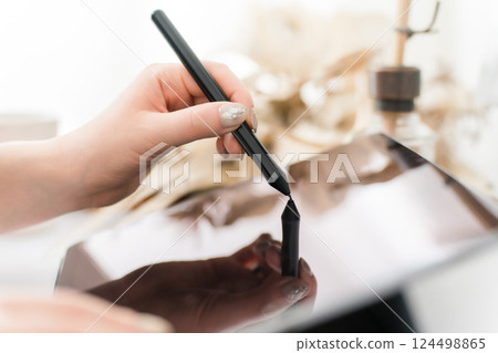 A woman drawing something on a tablet PC using a pen tablet (manga artist, creator, designer, animator) 124498865