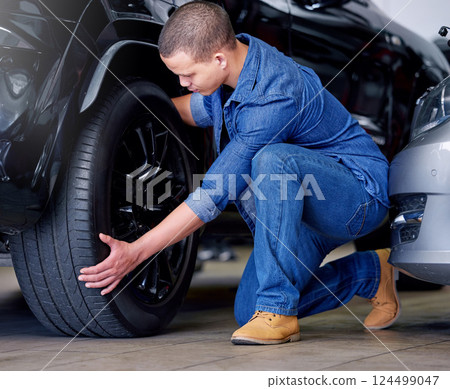 Man, car mechanic and tire change in garage, vehicle maintenance or service. Expert, professional and repairman in automobile workshop or auto shop working on wheel, tyre repair or safety inspection Man, car mechanic and tire change in garage, vehicle maintenance or service. Expert, professional and repairman in automobile workshop or auto shop working on wheel, tyre repair or safety inspection 124499047