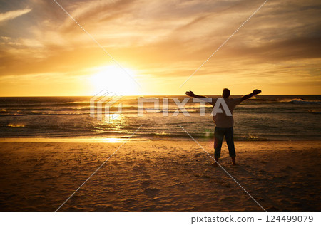 Freedom, beach and man silhouette celebration at sunset, happy and success in nature. Motivation, health, and energy challenge winner by a guy shadow cheering and express victory, happiness and joy 124499079