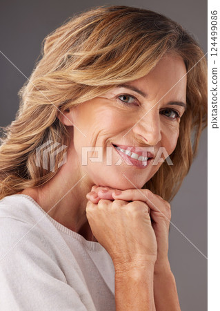 Mature woman, portrait of senior health and natural skincare beauty with antiaging happiness with a smile. Middle aged face, lady smiling and organic cosmetic spa treatment on gray studio background 124499086