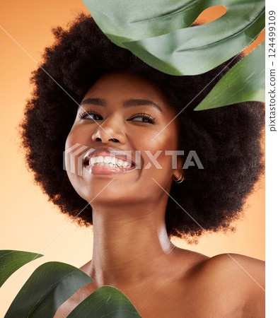 Beauty, skincare and black woman model with plants, skin health and natural hair glow smile. Happy, wellness and cosmetic happiness of a person from Jamaica feeling healthy smiling with a plant Beauty, skincare and black woman model with plants, skin health and natural hair glow smile. Happy, wellness and cosmetic happiness of a person from Jamaica feeling healthy smiling with a plant 124499109