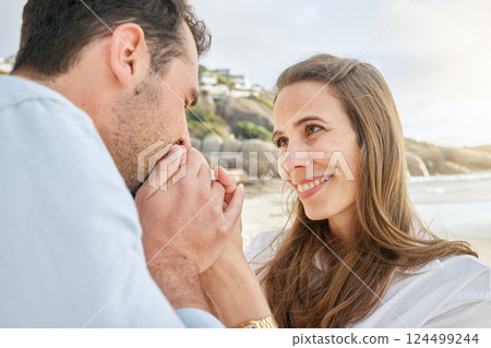 Kiss hands, couple and love, happy together on beach, adventure and travel while bonding, outdoor by the ocean. Man, woman and care, quality time by the sea, support and trust, relationship growth. 124499244