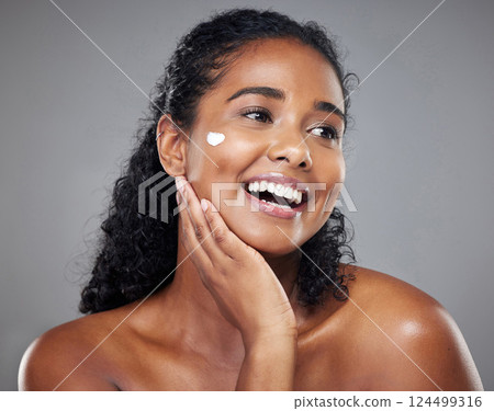 Cosmetics, black woman and cream with smile, wellness and health for natural beauty, happy and grey studio background. Makeup, healthy girl and skincare for organic facial, smooth skin and body care. 124499316