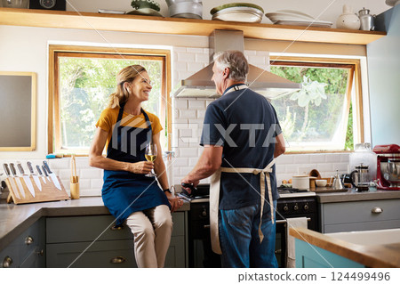 Retirement, senior couple and cooking in kitchen have discussion, talking or loving prepare meal together. Love, mature man and elderly woman is romantic, happy and smile to enjoy anniversary at home 124499496