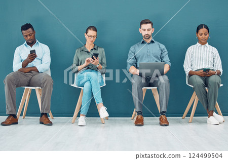 Business people, hiring and tech with some on mobile, laptop or tablet. Group of corporate workers, group or employee team on technology, computer or phone sitting and waiting for a job interview 124499504