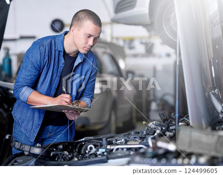Car service, inspection and mechanic by car with clipboard checking engine. Technician, engineer and man working in garage or workshop writing notes for repair, maintenance and motor care for vehicle 124499605