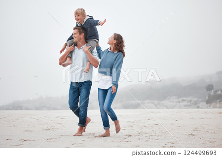 Family, children and beach with a mother, father and boy walking on the sand while on holiday or vacation. Nature, summer and travel with a man, woman and boy child taking walk together on the coast Family, children and beach with a mother, father and boy walking on the sand while on holiday or vacation. Nature, summer and travel with a man, woman and boy child taking walk together on the coast 124499693