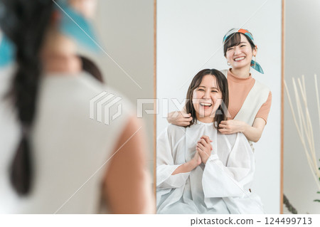 A woman who has completed a cut and hair set at a beauty salon / hair salon 124499713