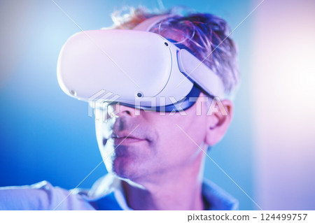 Virtual reality, digital and man in metaverse for future or 3d futuristic simulation technology in a studio. Innovation, cyber and mature person enjoys a gamers experience in high tech vr glasses 124499757