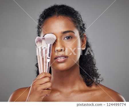 Beauty, black woman and portrait with brush cover on face for cosmetic powder or foundation tools. Makeup, cosmetics and brushes for beautiful girl model with grey studio mockup for marketing. Beauty, black woman and portrait with brush cover on face for cosmetic powder or foundation tools. Makeup, cosmetics and brushes for beautiful girl model with grey studio mockup for marketing. 124499774