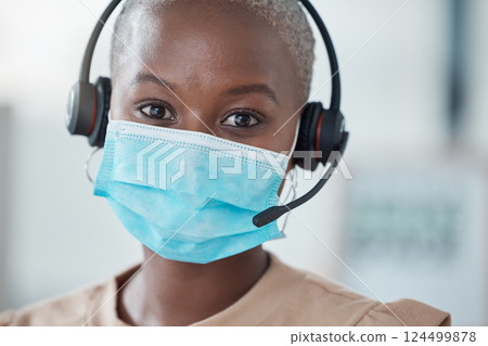 Covid, call center and customer service with a black woman consultant using a headset while working in her office. Crm, contact us and support with a female consulting in a telemarketing company 124499878
