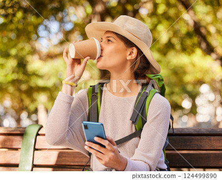 Woman, phone and coffee in relax for backpacking on park bench for nature adventure in the outdoors. Female hiker or explorer relaxing on smartphone and drinking beverage with 5G connection for GPS Woman, phone and coffee in relax for backpacking on park bench for nature adventure in the outdoors. Female hiker or explorer relaxing on smartphone and drinking beverage with 5G connection for GPS 124499890