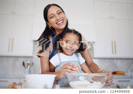 Mother, baking and bonding of a girl with mama learning in a home kitchen with a smile. Portrait of a happy black mom with cooking, love and care holding her kid in a house together smiling 124499908