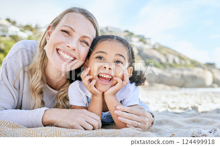 Mom, beach and girl lying for portrait with love, smile or happy for adoption, outdoor or sunshine. Woman, mother and child on blanket at ocean, sand or sea on holiday, vacation or family in summer Mom, beach and girl lying for portrait with love, smile or happy for adoption, outdoor or sunshine. Woman, mother and child on blanket at ocean, sand or sea on holiday, vacation or family in summer 124499918