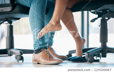 Feet, flirt and affair with a work romance between and business man and woman in the office together. Couple, shoes and love with a male and female flirting under a table at work in infidelity 124500067