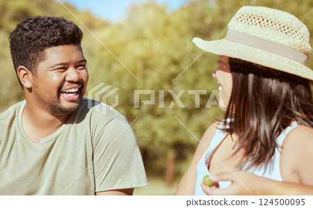 Happy, love and couple in nature in a conversation while on an outdoor garden picnic date in summer. Happiness, communication and young man and woman with a smile talking in a park to relax together. 124500095