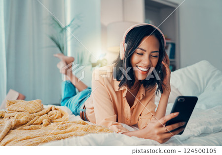 Woman, phone and headphone relax, streaming music online or audio. Radio, podcast and content for entertainment on the internet or happy free time listening on earphones in home bedroom in peace 124500105