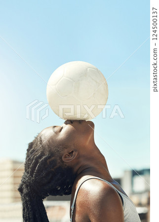 Soccer, ball and head balance of a black woman doing fitness outdoor for sports. Football, exercise and workout training before a game with calm, mindfulness and relax athlete for health 124500137