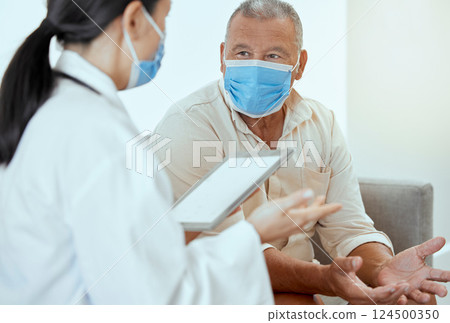 Covid, senior patient and doctor with tablet, discussion for medical results and appointment in hospital. Mockup, medical professional and man with mask talk, speaking and consultation for healthcare Covid, senior patient and doctor with tablet, discussion for medical results and appointment in hospital. Mockup, medical professional and man with mask talk, speaking and consultation for healthcare 124500350