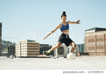 Soccer player, woman and soccer ball kick in fitness, training or exercise on Portugal city building rooftop. Football player, sports person and athlete in energy workout for health or wellness goals 124500524