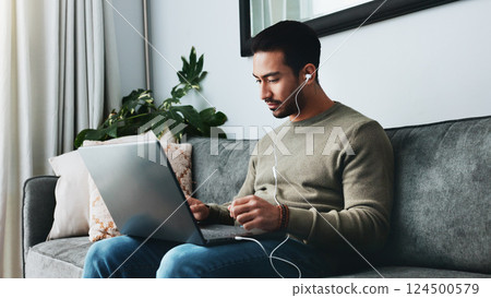 Home, earphones and man with laptop on sofa for watching video for online course, lesson and tutorial. Remote work, living room and person on computer listening to podcast, audio and recording Home, earphones and man with laptop on sofa for watching video for online course, lesson and tutorial. Remote work, living room and person on computer listening to podcast, audio and recording 124500579