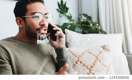 Phone call, upset and man on sofa in home for communication, social networking and talking. Living room, crisis and frustrated person on smartphone for contact, online conversation and connection 124500608