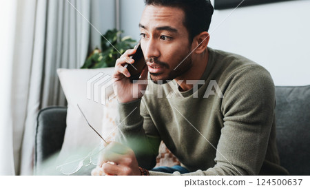 Phone call, listening and man on sofa in home for communication, social networking and chatting. Living room, house and frustrated person on smartphone for contact, online conversation and connection 124500637