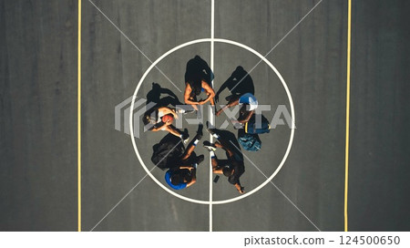 Basketball, team and game strategy, fitness and training motivation, team building and planning practice. Athlete, diversity and sport, men together on basketball court and ball with top view. 124500650
