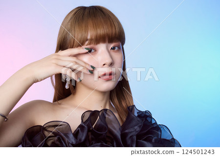Portrait of a female model wearing a black ruffled dress Portrait of a female model wearing a black ruffled dress 124501243