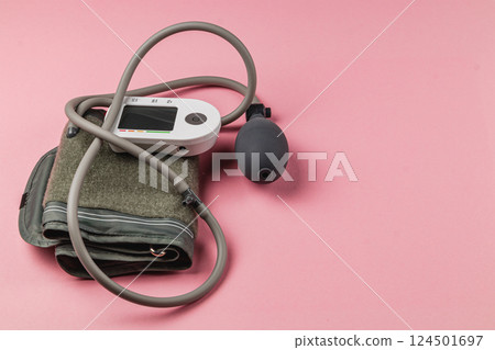 Automatic blood pressure monitor on a pink background Automatic blood pressure monitor on a pink background 124501697