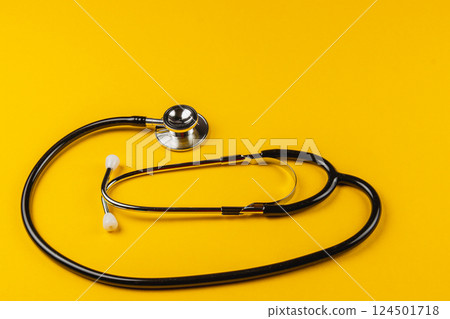 Stethoscope on bright yellow background with smooth curves Stethoscope on bright yellow background with smooth curves 124501718