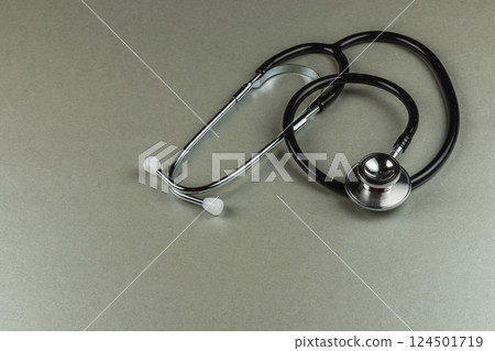 Stethoscope resting on a gray surface in quiet setting Stethoscope resting on a gray surface in quiet setting 124501719