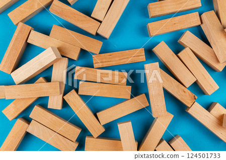 Wooden blocks scattered on a blue background 124501733
