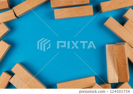 Wooden blocks arranged on a blue background for play 124501734