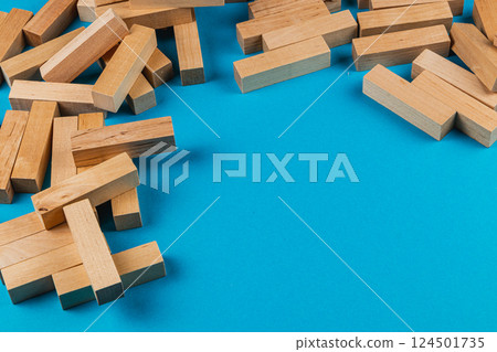 Wooden blocks scattered on blue surface for play 124501735