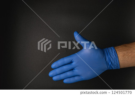 Blue rubber glove reaching out to shake hands in silhouette 124501770