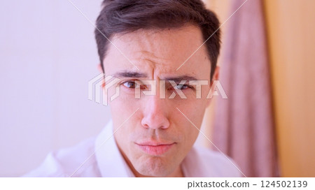 Confident man looking at himself in the mirror Confident man looking at himself in the mirror 124502139