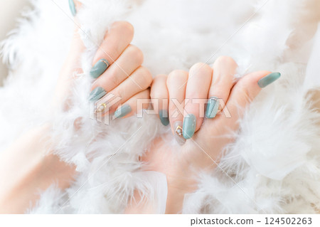 Woman's hands with gel nails and nail art at a nail salon 124502263