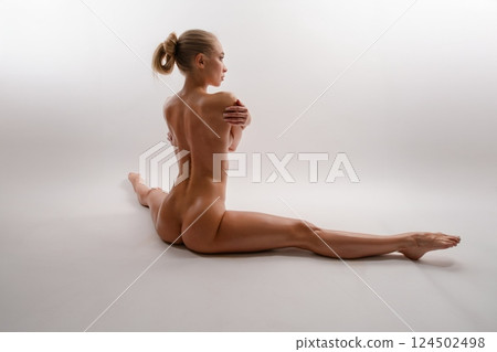 Elegant topless woman poses gracefully in a serene studio setting Elegant topless woman poses gracefully in a serene studio setting 124502498